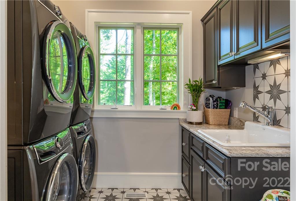 146 Allison Creek Trail Brevard, NC 28712 - Photo 16 of 48 a kitchen with a sink a window and a washer dryer