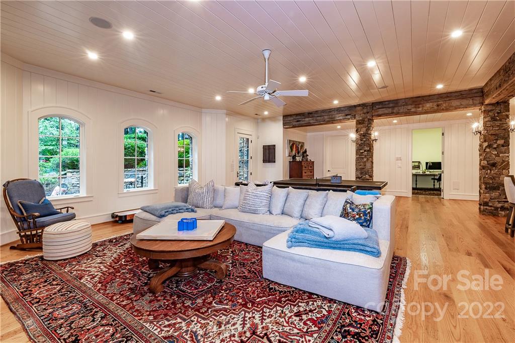146 Allison Creek Trail Brevard, NC 28712 - Photo 32 of 48 a living room with furniture a table and a chandelier