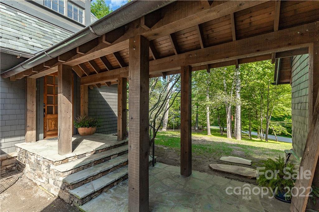 146 Allison Creek Trail Brevard, NC 28712 - Photo 41 of 48 a view of a porch with furniture and floor to ceiling window