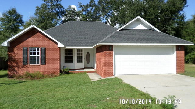4227 Jernigan Road Pace, FL 32571 - Photo 1 of 19 a front view of a house with a yard and garage