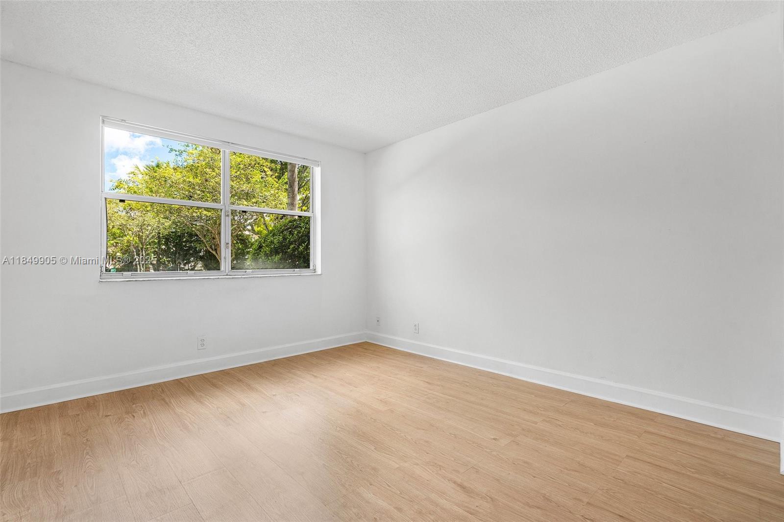 8721 Wiles Road, Unit 105 Coral Springs, FL 33067 - Photo 14 of 49 an empty room with a window