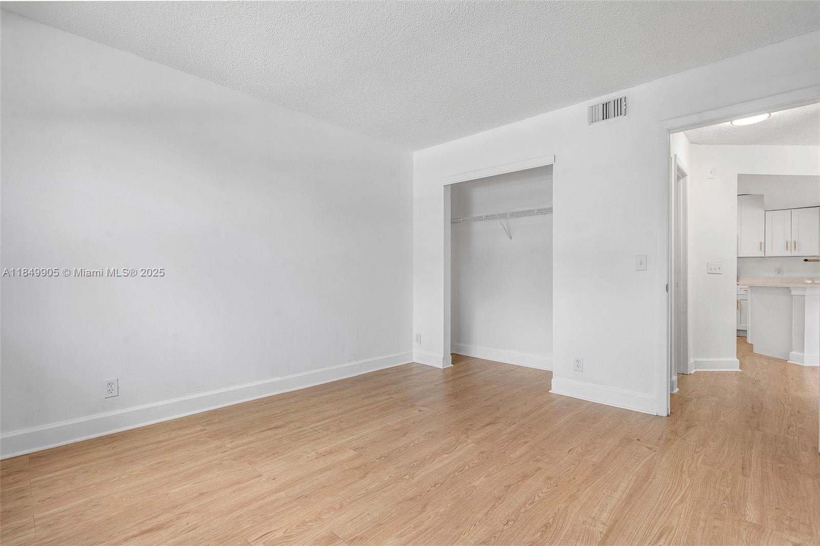 8721 Wiles Road, Unit 105 Coral Springs, FL 33067 - Photo 17 of 49 a view of an empty room with wooden floor & closet