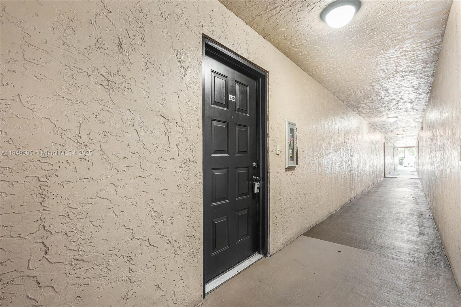 8721 Wiles Road, Unit 105 Coral Springs, FL 33067 - Photo 18 of 49 a hallway with a door
