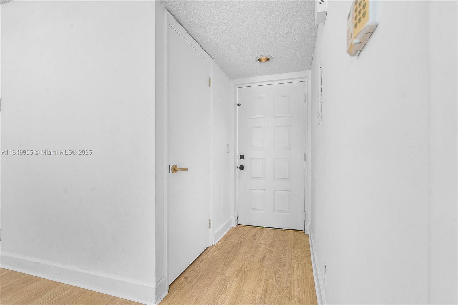 8721 Wiles Road, Unit 105 Coral Springs, FL 33067 - Photo 19 of 49 a view of a hallway with wooden floor