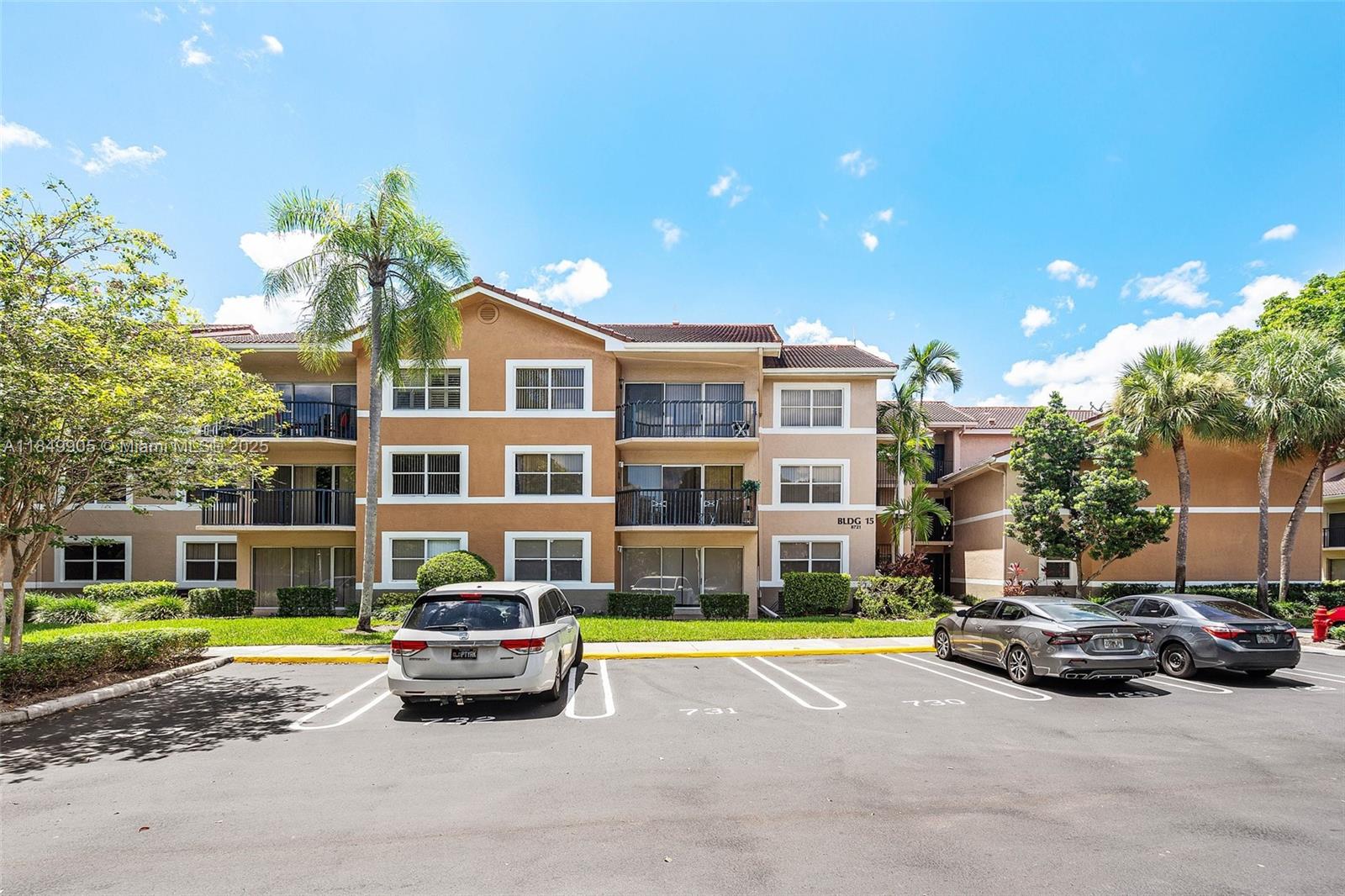 8721 Wiles Road, Unit 105 Coral Springs, FL 33067 - Photo 2 of 49 a car parked in front of a brick house