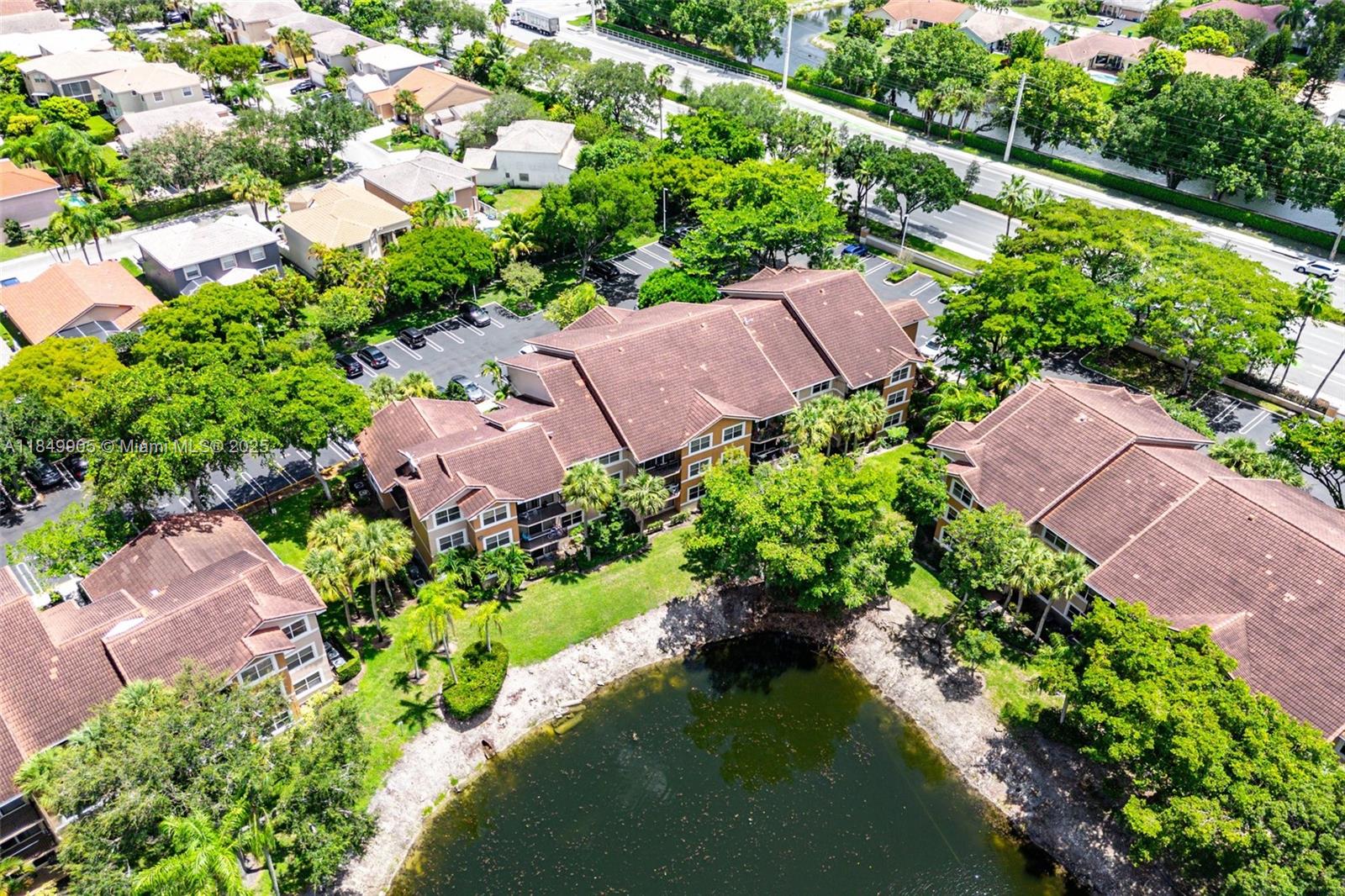 8721 Wiles Road, Unit 105 Coral Springs, FL 33067 - Photo 32 of 49 an aerial view of a house with garden space and street view
