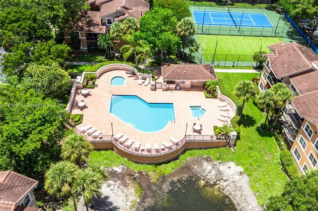an aerial view of a house with a yard