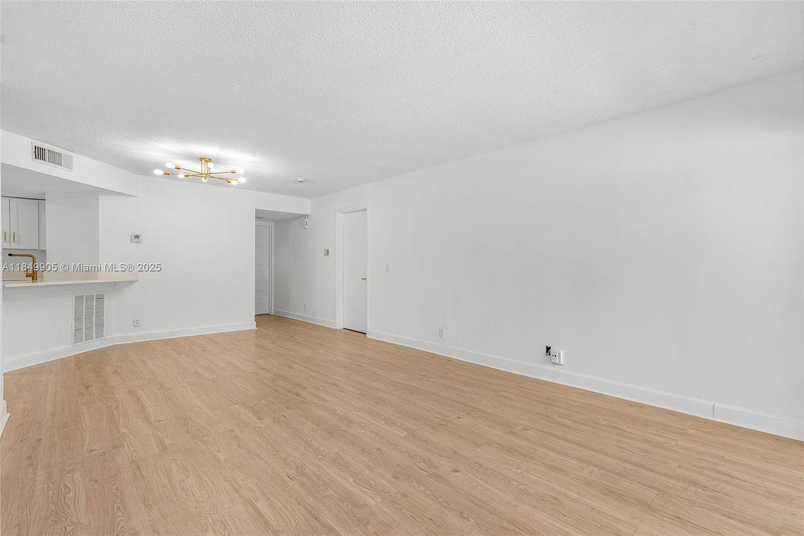 8721 Wiles Road, Unit 105 Coral Springs, FL 33067 - Photo 5 of 49 a view of a kitchen with an empty space and a sink