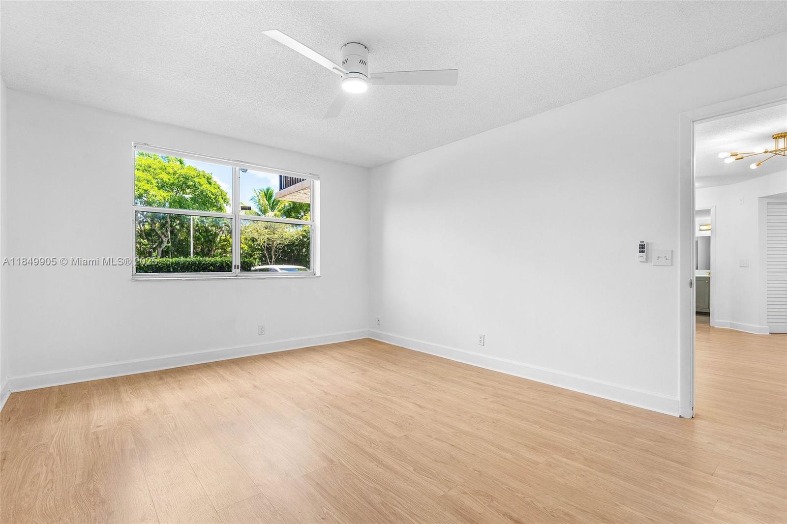 8721 Wiles Road, Unit 105 Coral Springs, FL 33067 - Photo 10 of 49 an empty room with a window