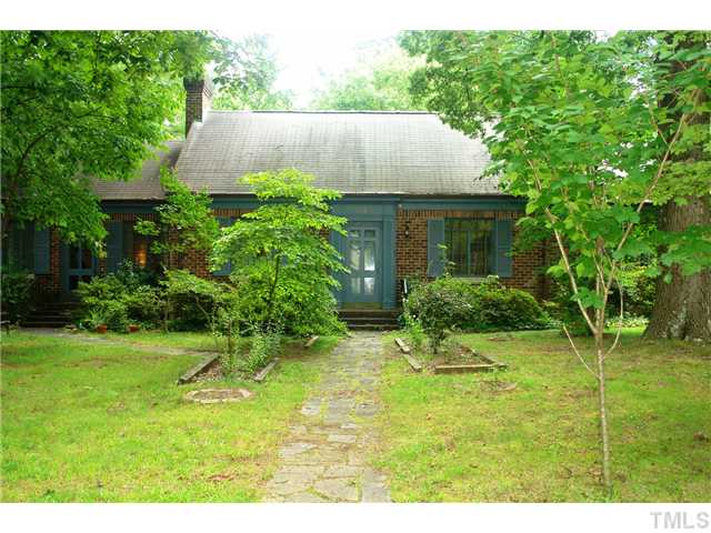 a view of an house with backyard space and garden