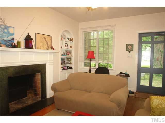 412 Dixie Trail Raleigh, NC 27607 - Photo 6 of 15 a living room with furniture a fireplace and a large window