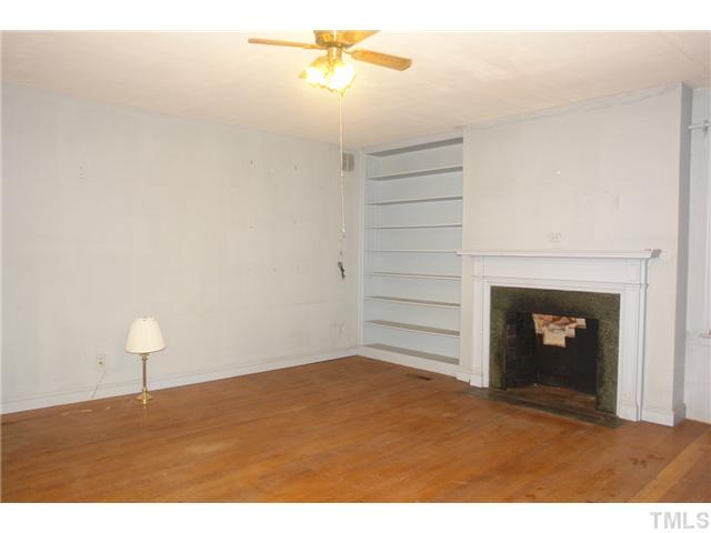 412 Dixie Trail Raleigh, NC 27607 - Photo 7 of 15 a view of empty room with a fireplace and wooden floor