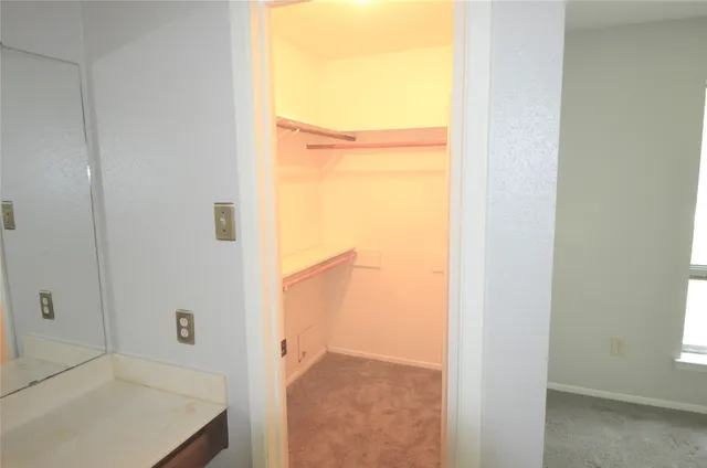 a view of a hallway with a bathroom