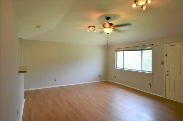 wooden floor in an empty room with a window