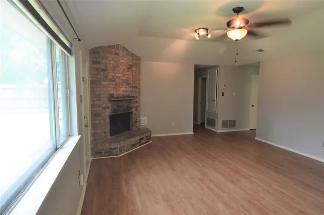 wooden floor in an empty room with a fireplace