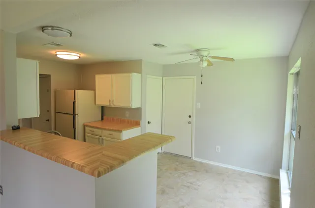 a kitchen with stainless steel appliances granite countertop a sink and a refrigerator