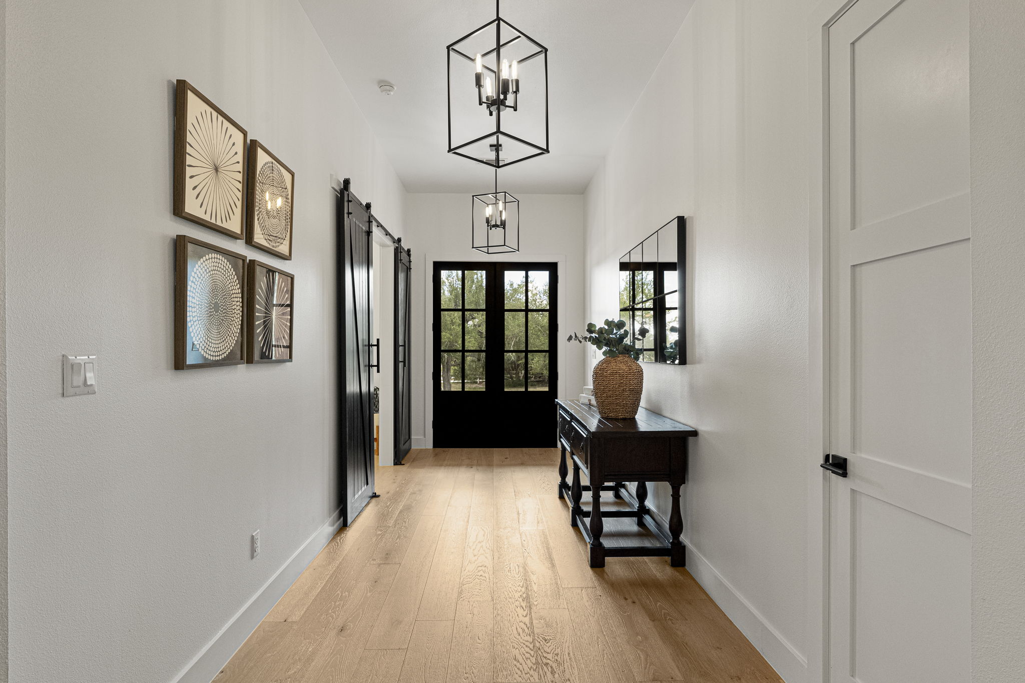 32831 Ranch Road 12 Dripping Springs, TX 78620 - Photo 6 of 40 This warm entryway invites you inside with the solid iron doors and white oak flooring.