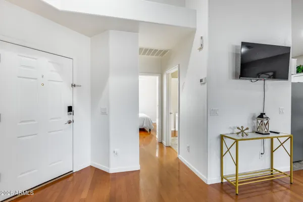 a view of room with hardwood floor and tub