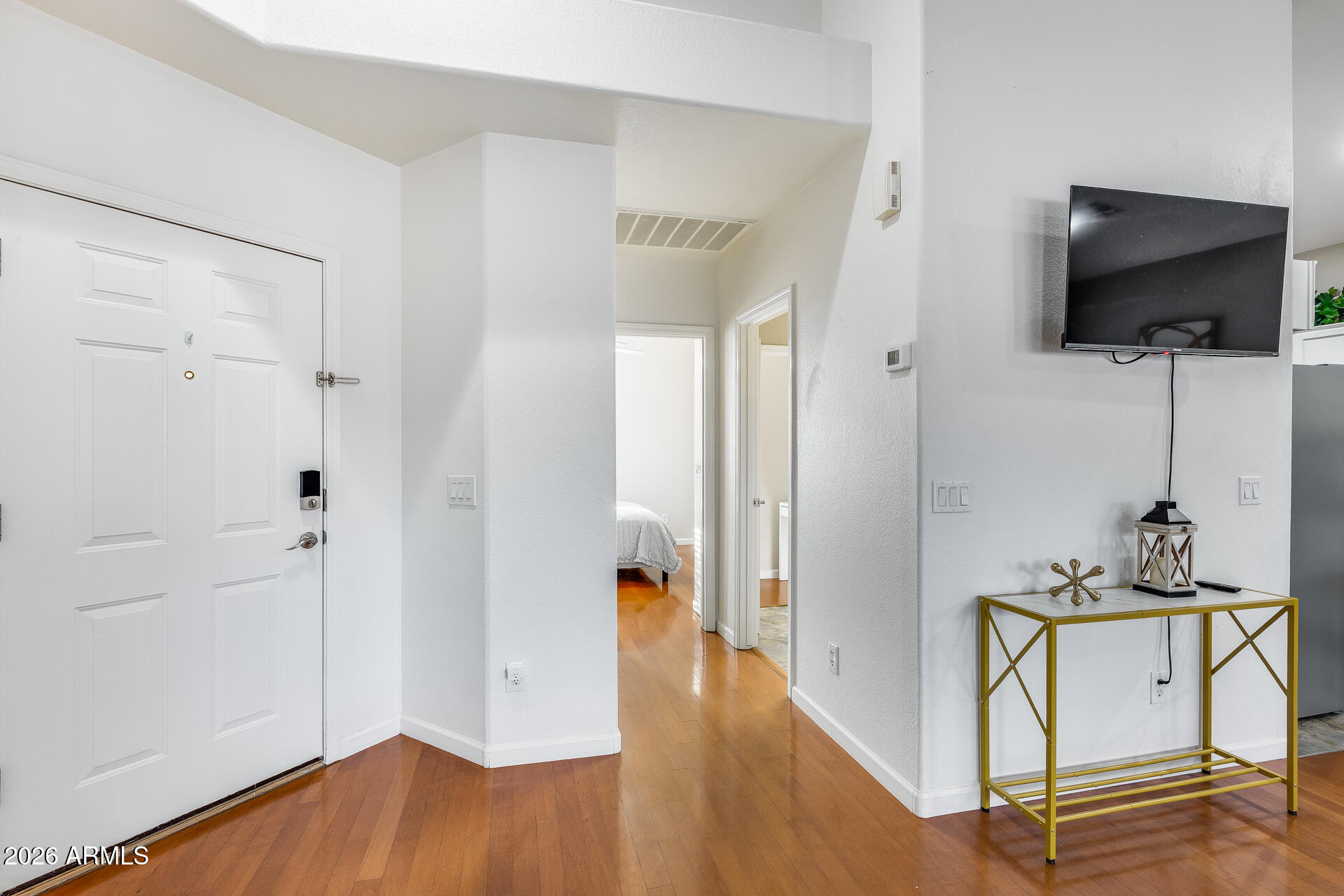 3252 East Fremont Road Phoenix, AZ 85042 - Photo 12 of 45 a view of a room with wooden floor and flat screen tv