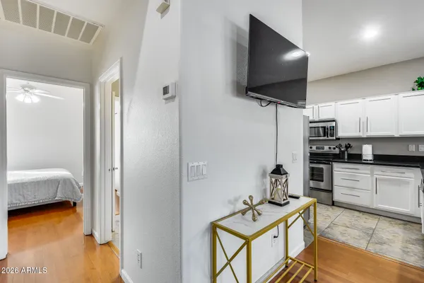 a view of a room with wooden floor and flat screen tv