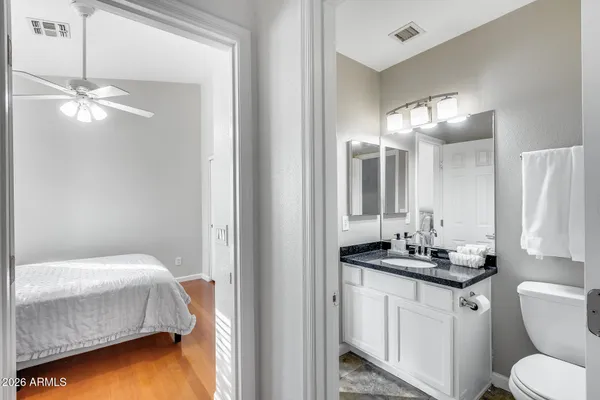 a kitchen with furniture a flat screen tv and a refrigerator