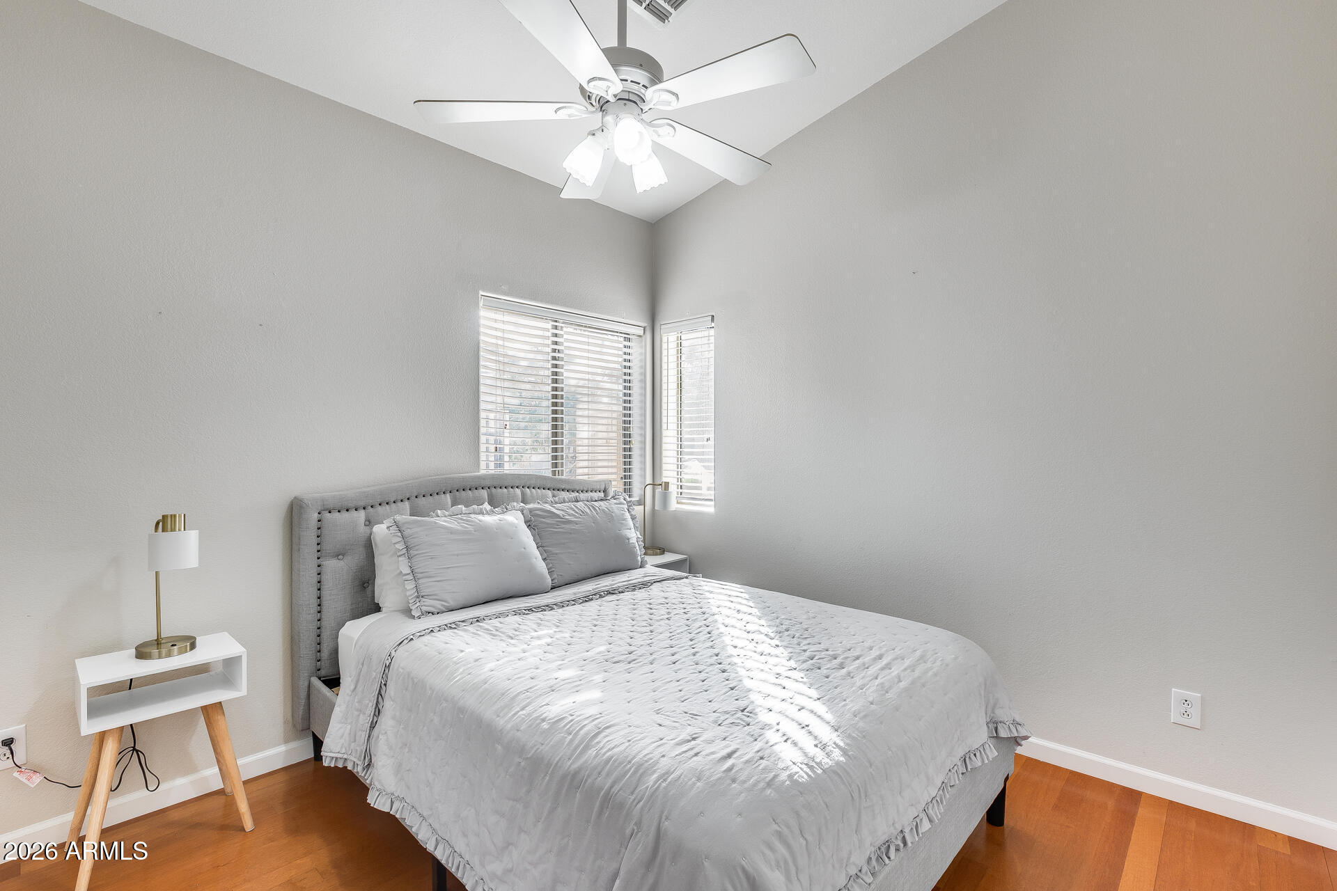 3252 East Fremont Road Phoenix, AZ 85042 - Photo 15 of 45 a bedroom with a bed and a chandelier