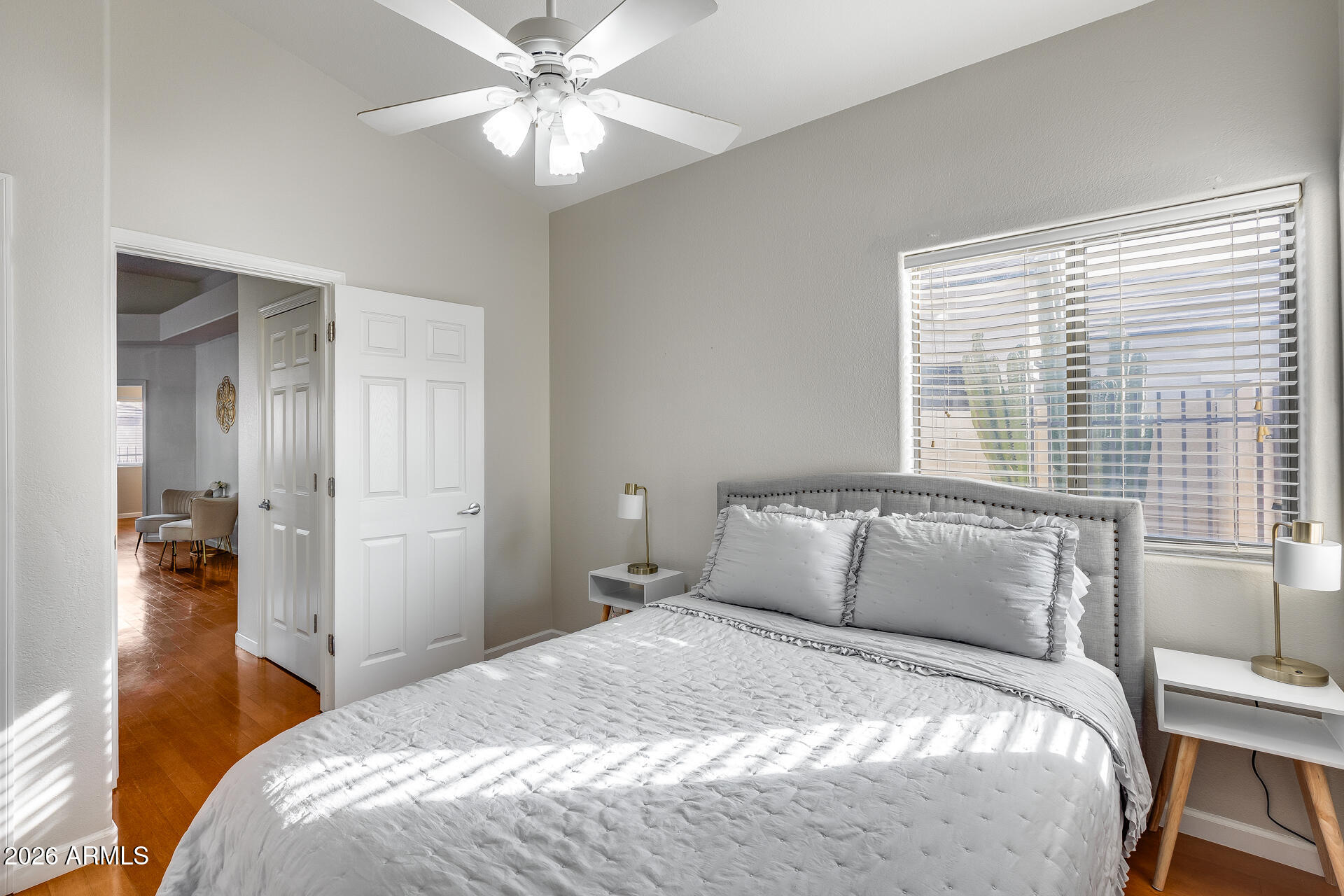 3252 East Fremont Road Phoenix, AZ 85042 - Photo 16 of 45 a bedroom with a bed and a chandelier
