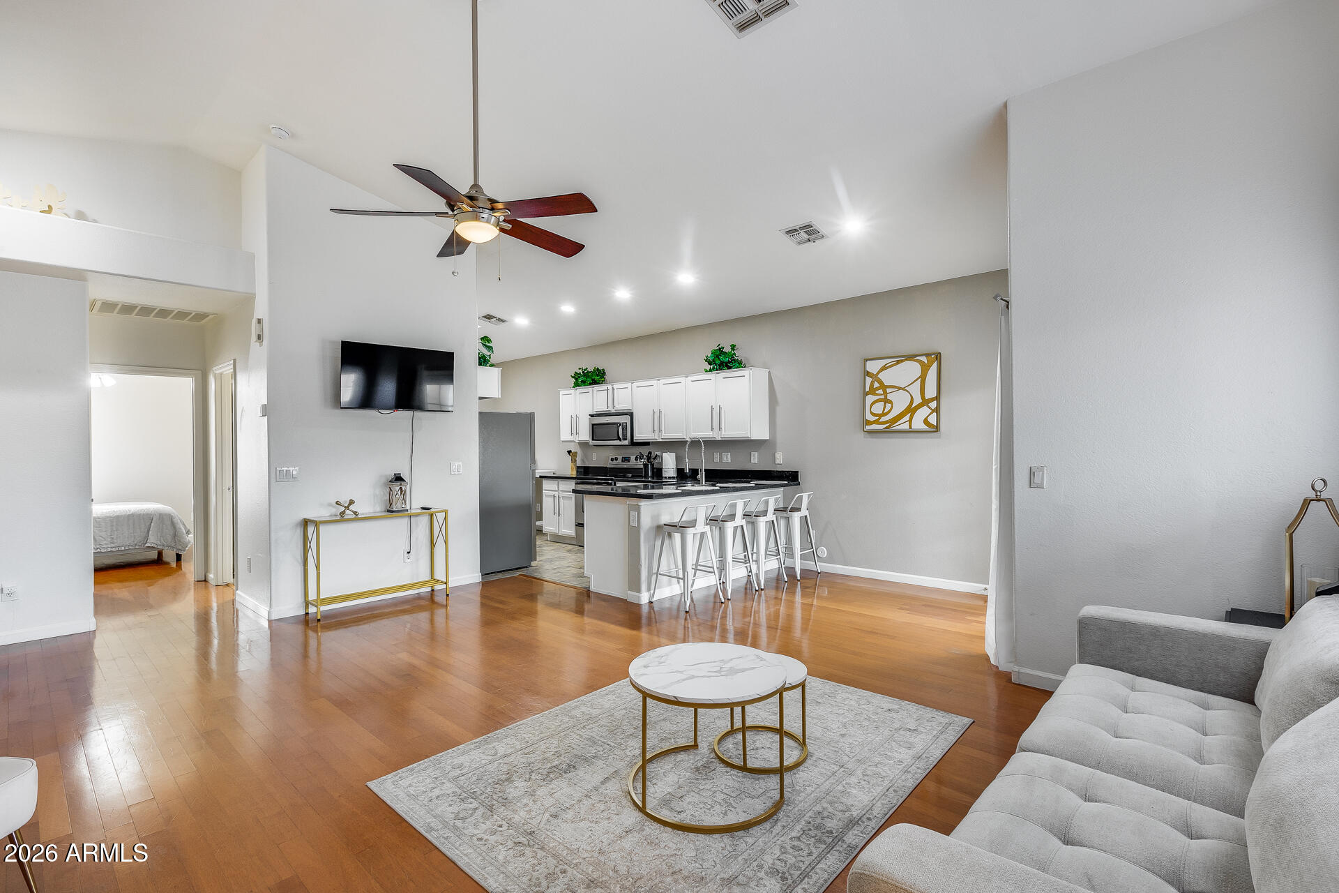 3252 East Fremont Road Phoenix, AZ 85042 - Photo 18 of 45 a living room with furniture kitchen view and a wooden floor