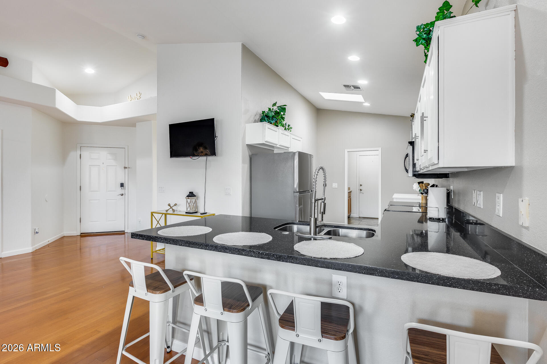 3252 East Fremont Road Phoenix, AZ 85042 - Photo 22 of 45 a kitchen with a dining table chairs and white cabinets