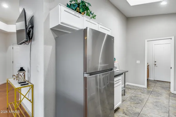 a kitchen with granite countertop white cabinets stainless steel appliances and a sink