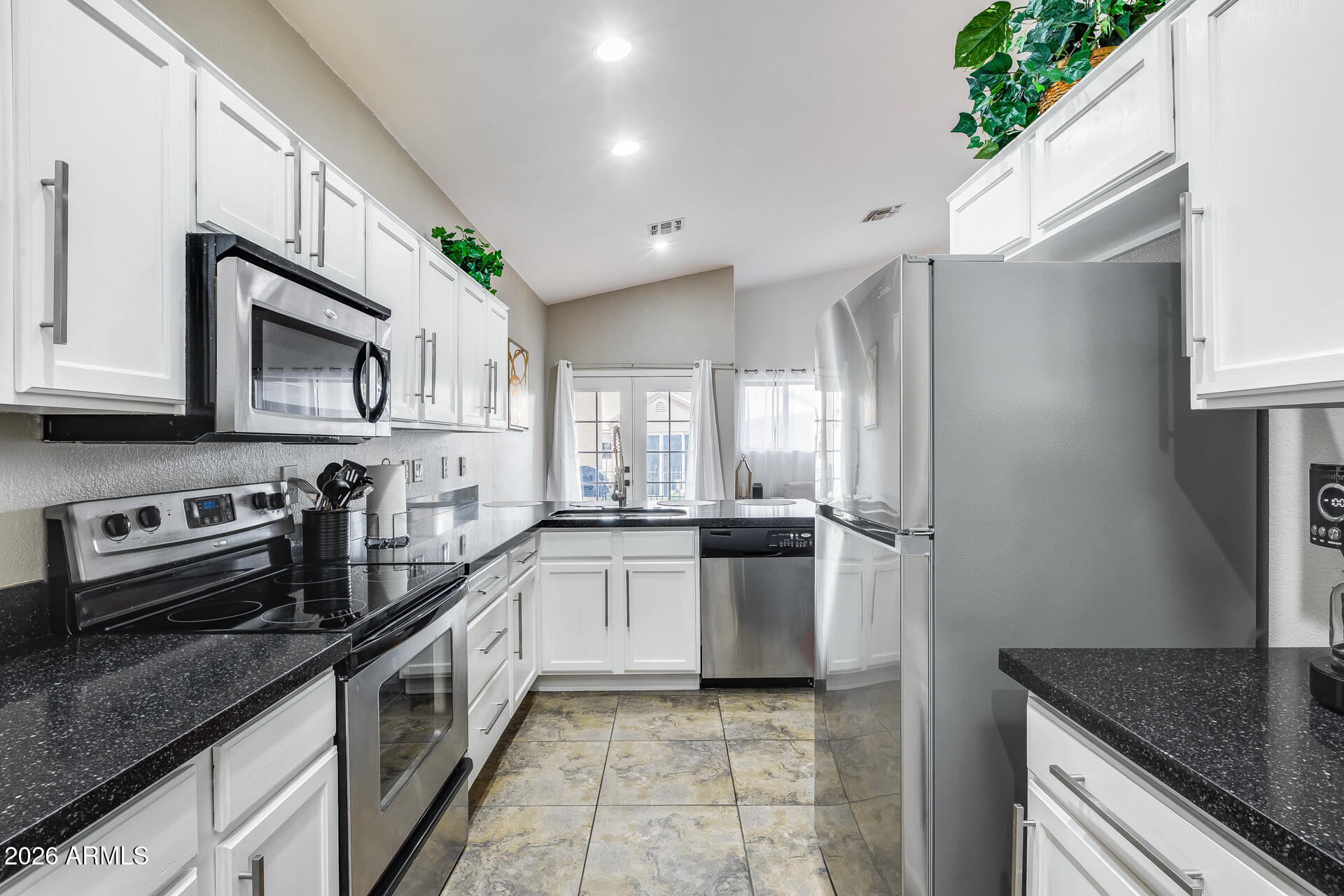 3252 East Fremont Road Phoenix, AZ 85042 - Photo 26 of 45 a kitchen with stainless steel appliances granite countertop a sink stove and refrigerator