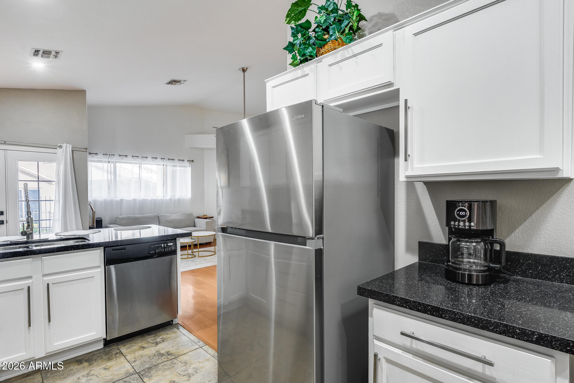 3252 East Fremont Road Phoenix, AZ 85042 - Photo 27 of 45 a kitchen with stainless steel appliances granite countertop a refrigerator a sink a stove and white cabinets