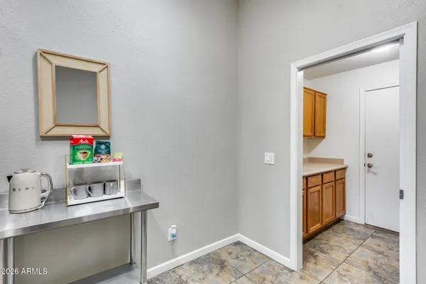 a kitchen with stainless steel appliances granite countertop a refrigerator a sink a stove and white cabinets