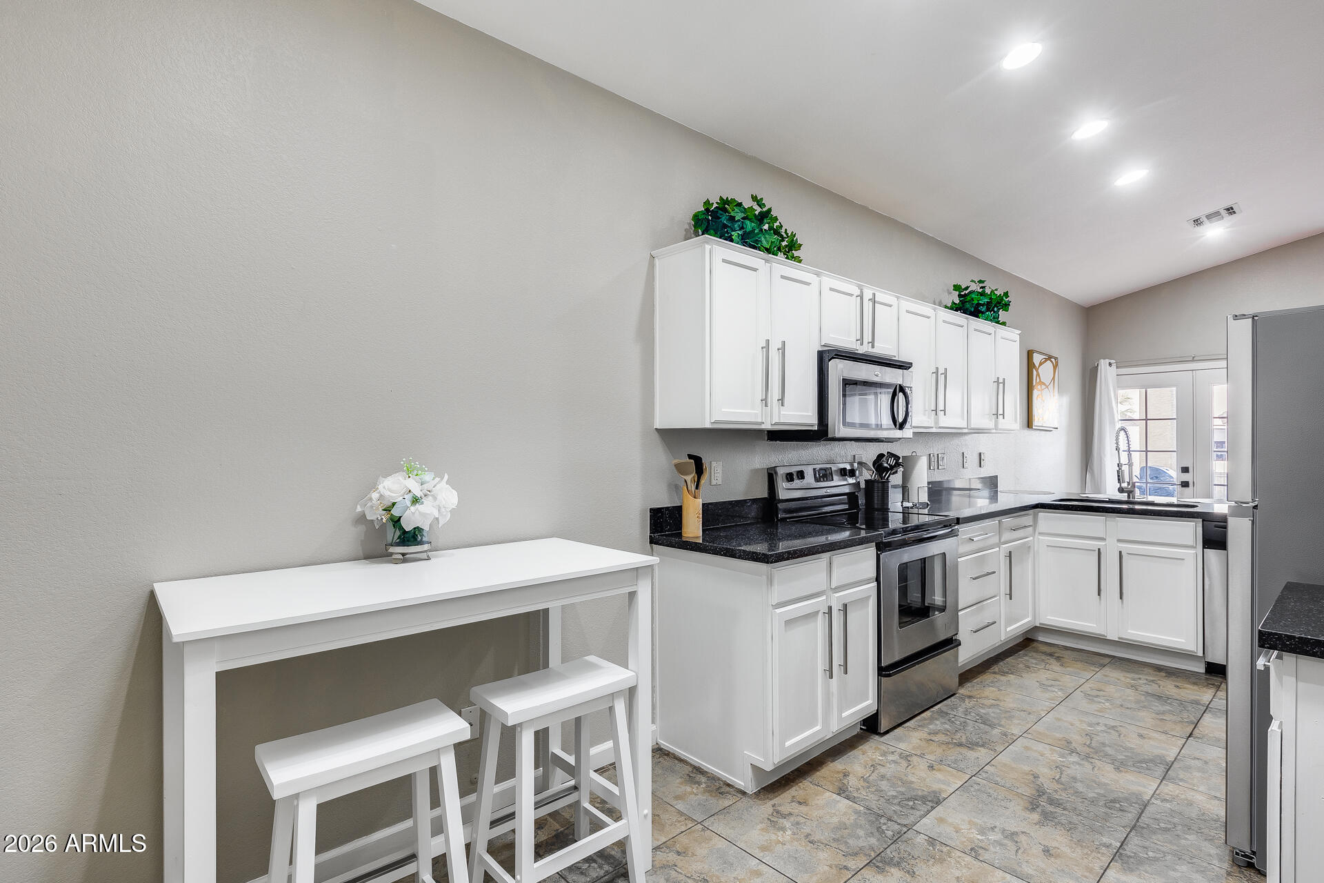 3252 East Fremont Road Phoenix, AZ 85042 - Photo 29 of 45 a kitchen with granite countertop a sink cabinets and stainless steel appliances