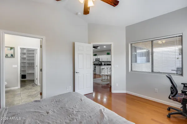 a bedroom with a bed and a chandelier