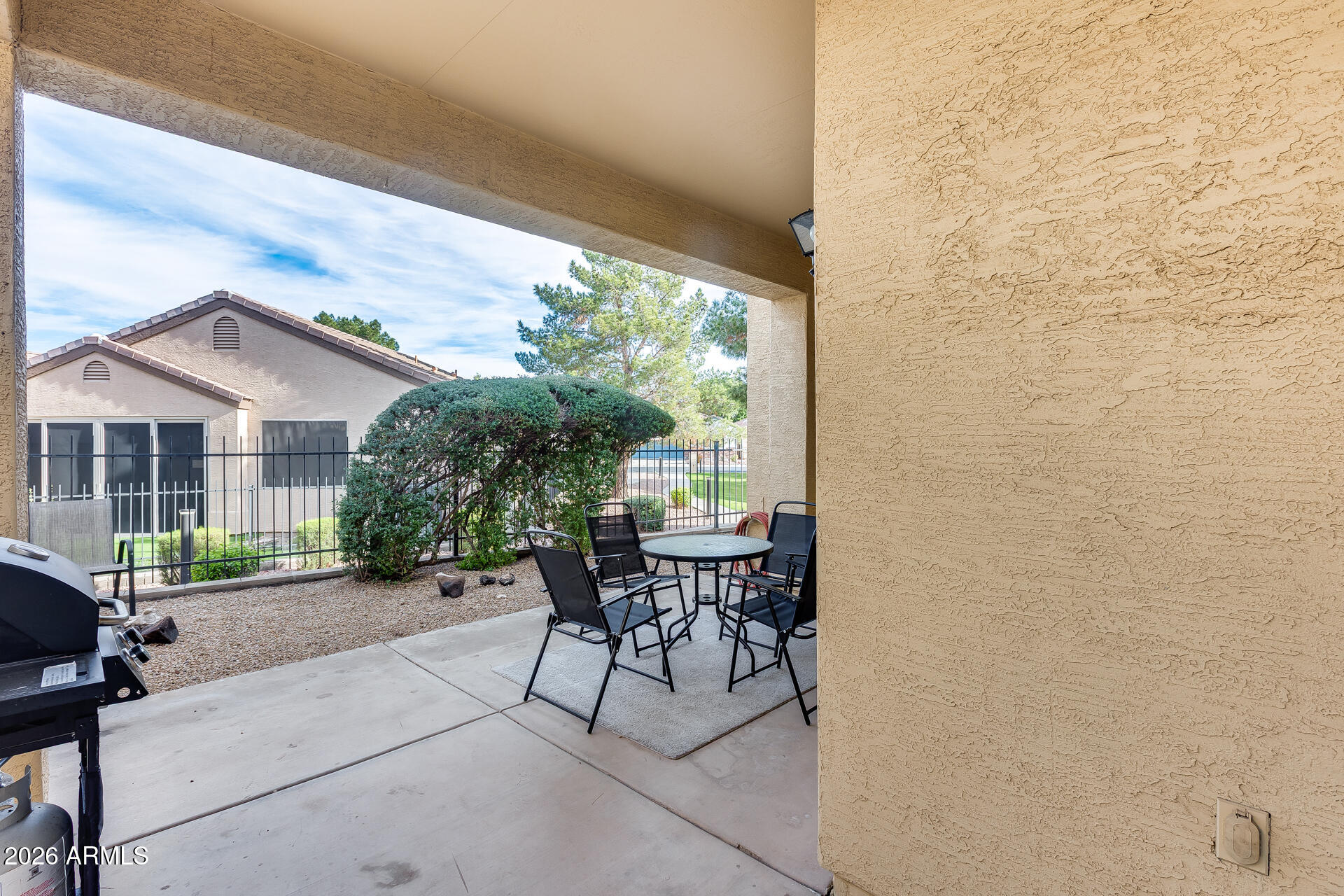 3252 East Fremont Road Phoenix, AZ 85042 - Photo 40 of 45 a patio with table and chairs and potted plants