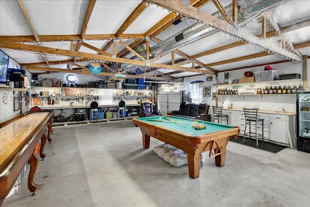 a room with lots of wooden furniture with windows