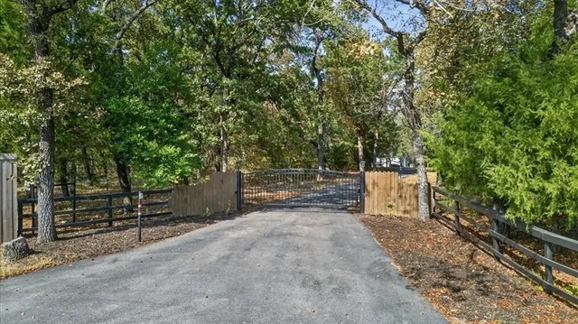 a view of a park with iron fence