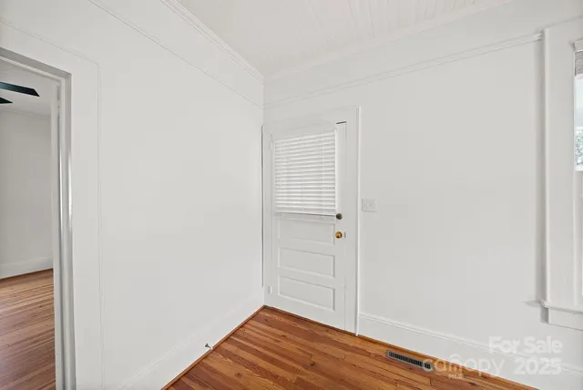 a view of a room with wooden floor and closet