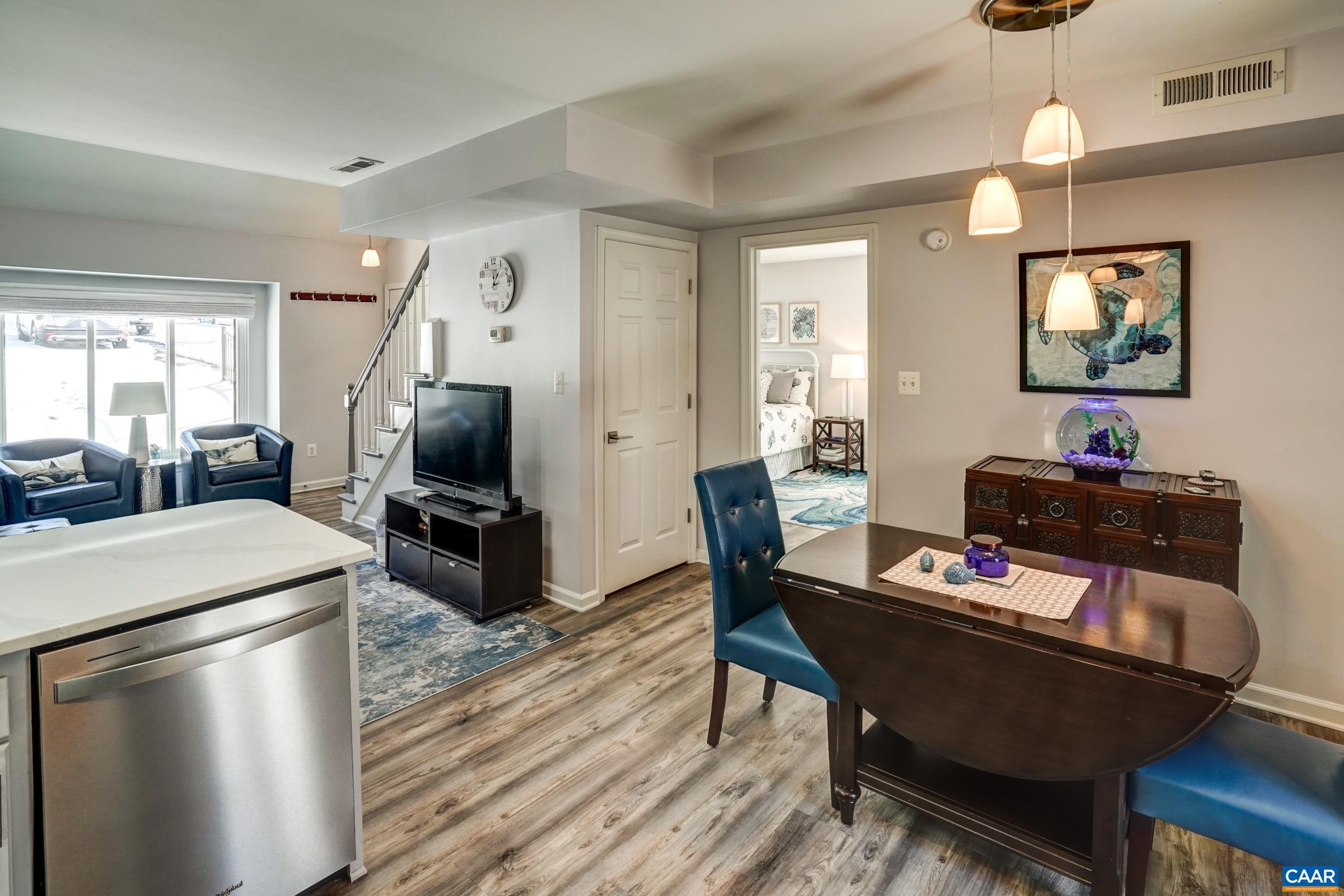 1008 Highlands Drive Charlottesville, VA 22901 - Photo 13 of 41 a living room with furniture a flat screen tv and a dining table