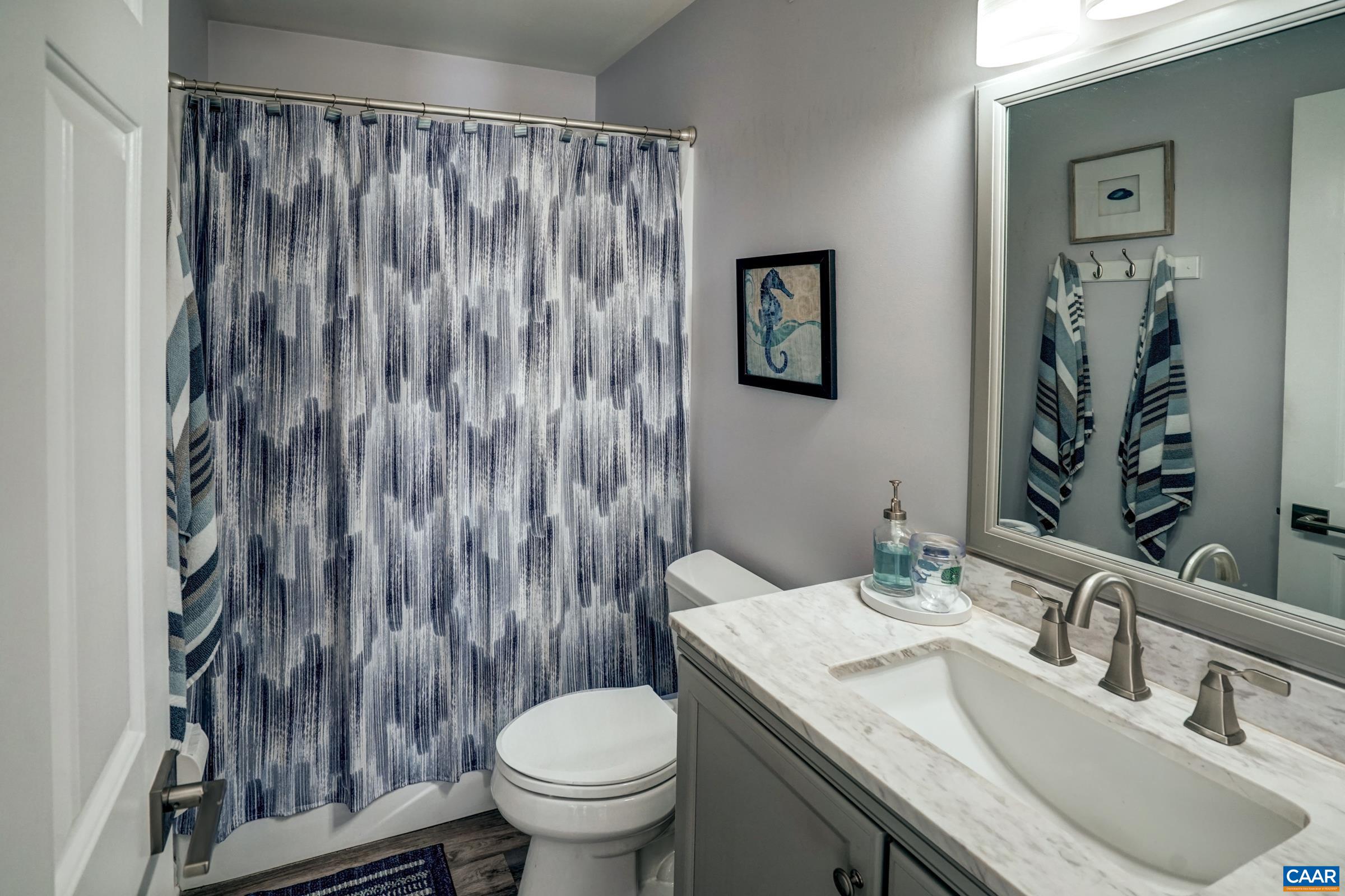 1008 Highlands Drive Charlottesville, VA 22901 - Photo 20 of 41 a bathroom with a granite countertop sink toilet and a mirror
