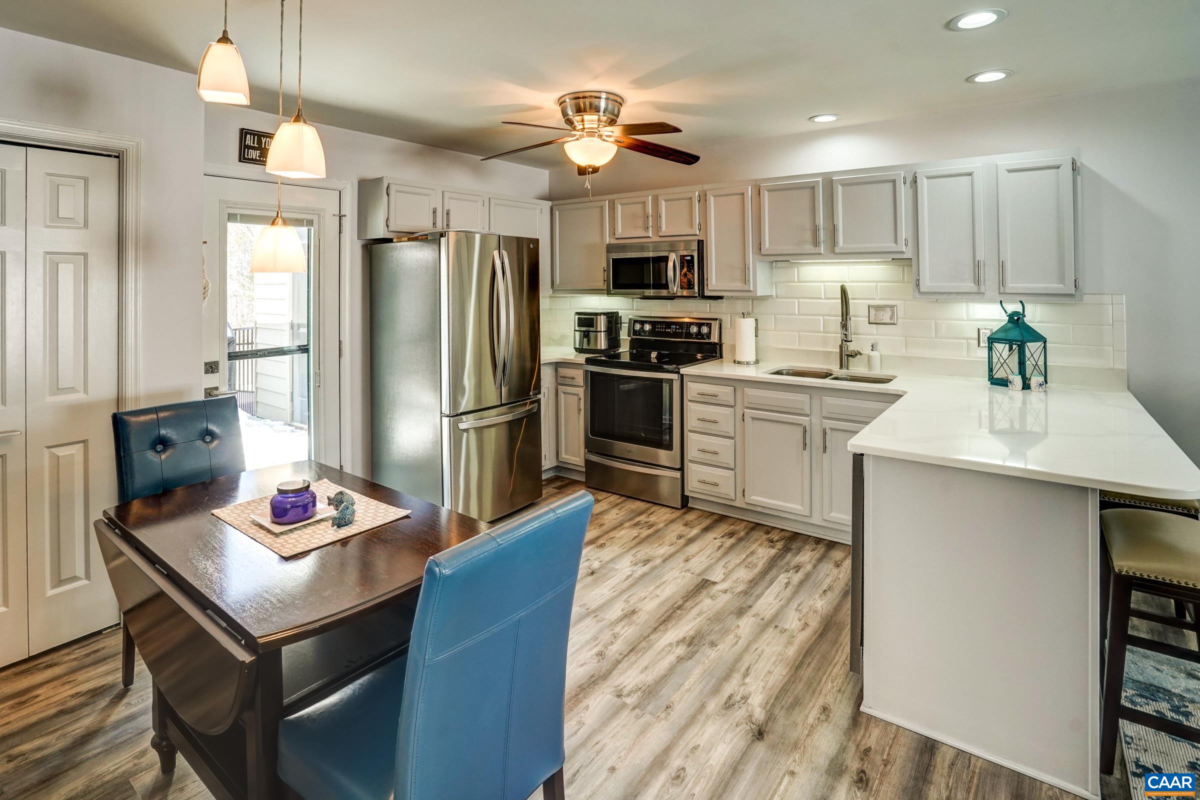 1008 Highlands Drive Charlottesville, VA 22901 - Photo 9 of 41 a kitchen with granite countertop stainless steel appliances a sink dishwasher a refrigerator a stove top oven a counter space and wooden floor