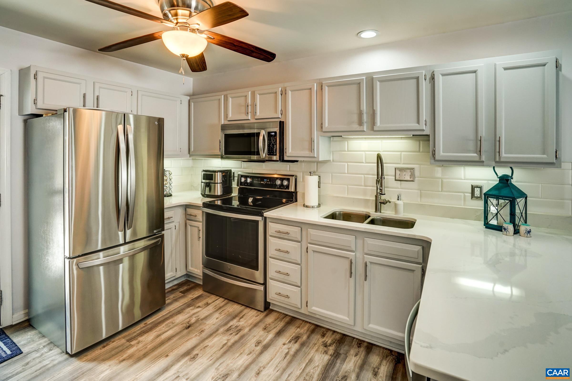 1008 Highlands Drive Charlottesville, VA 22901 - Photo 10 of 41 a kitchen with stainless steel appliances a refrigerator sink and microwave