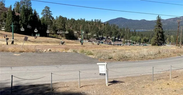 a view of a road with a snow in the background