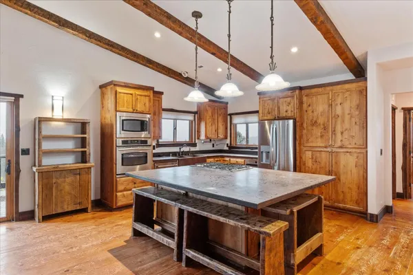a kitchen with stainless steel appliances granite countertop a refrigerator stove and oven