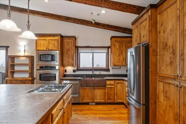 a kitchen with stainless steel appliances granite countertop a stove and a microwave