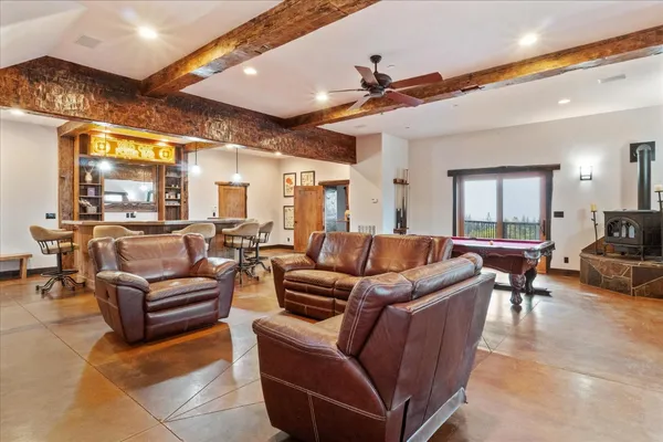 a dining hall with furniture and wooden floor