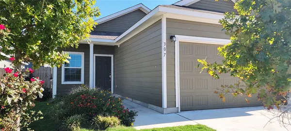 a view of a house with potted plants