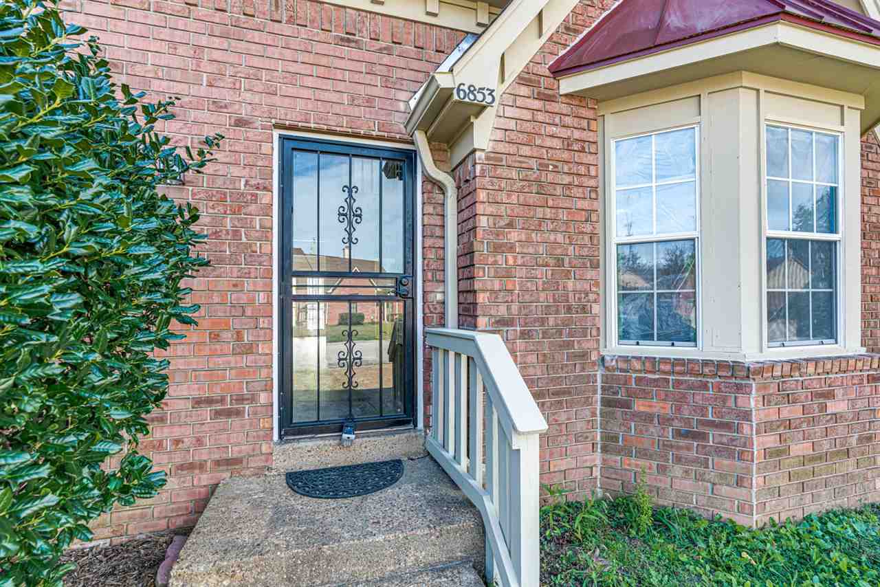 6853 Snyder Road Memphis, TN 38141 - Photo 2 of 23 a brick house with a large windows