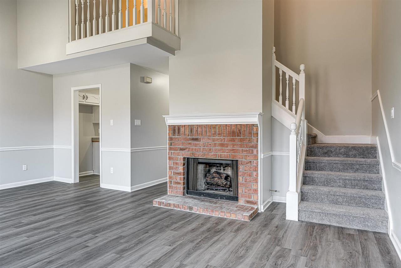 6853 Snyder Road Memphis, TN 38141 - Photo 5 of 23 wooden floor fireplace and windows in an empty room